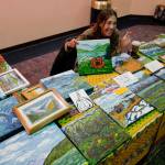 Liz Saya shows her paintings at Centennial Hall during Gallery Walk on Friday, Dec. 6, 2019. (Michael Penn | Juneau Empire)