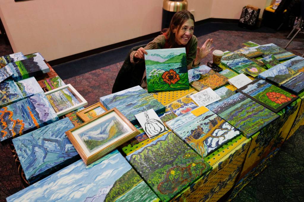 Liz Saya shows her paintings at Centennial Hall during Gallery Walk on Friday, Dec. 6, 2019. (Michael Penn | Juneau Empire)