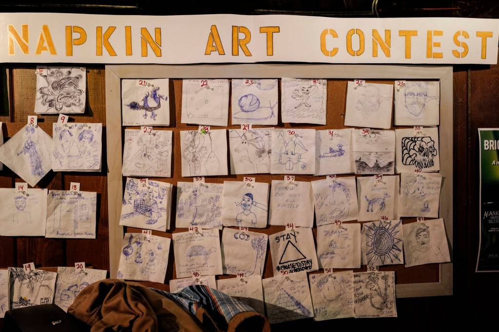 Napkin Art Contest contenders at the Triangle Bar during Gallery Walk on Friday, Dec. 6, 2019. (Michael Penn | Juneau Empire)