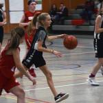 Dzantiki Heenis Rayna Tuckwood pushes the ball as teammate Jenna Dobson, far right, keeps pace during a round-robin game at the Icebreaker Tournament at FDMS on Friday, Dec. 6, 2019. (Nolin Ainsworth | Juneau Empire)
