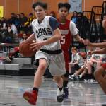 Dzantiki Heenis Sam Lockhart steps around Floyd Drydens Joren Gasga during a round-robin game at the Icebreaker Tournament at FDMS on Friday, Dec. 6, 2019. (Nolin Ainsworth | Juneau Empire)