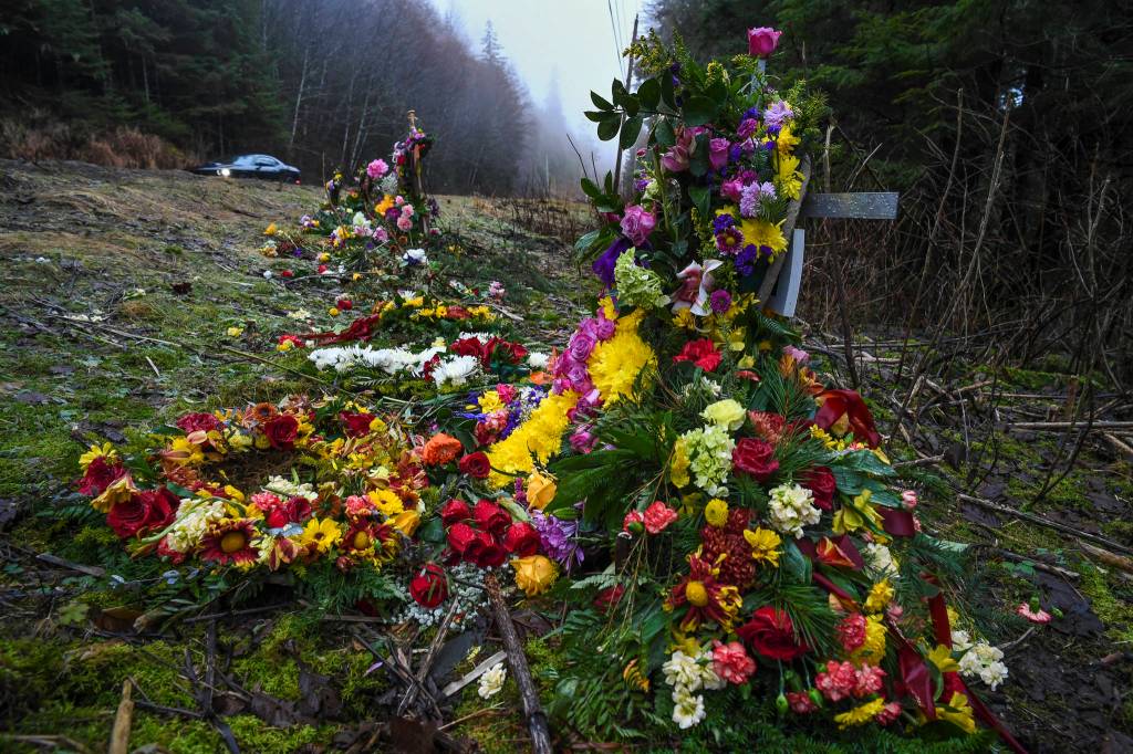 Two crosses ladened with flowers memorialize a 19-year-old woman and a 15-year-old boy who were killed in an vehicle accident near Mile 20 on Glacier Highway on Nov. 21. Two others were injured. (Michael Penn | Juneau Empire)
