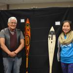 Wayne Price, associate professor of Northwest Coast art and Tlingit artist, and student Kaytlynne Lewis pose with their paddles at a recent Northwest Coast arts showcase. (Courtesy Photo | Davina Cole)