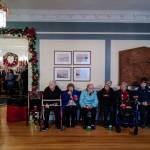 Members of the Bridge Adult Daycare eat their cookies while visiting the Governors Open House on Tuesday, Dec. 10, 2019. (Michael Penn | Juneau Empire)