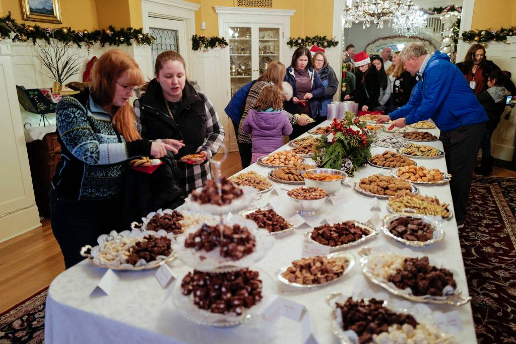 Juneau residents choose their cookies at the Governors Open House on Tuesday, Dec. 10, 2019. (Michael Penn | Juneau Empire)