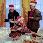 Ben and April Nestler, with their daughter, Ellie, choose their cookies at the Governors Open House on Tuesday, Dec. 10, 2019. (Michael Penn | Juneau Empire)
