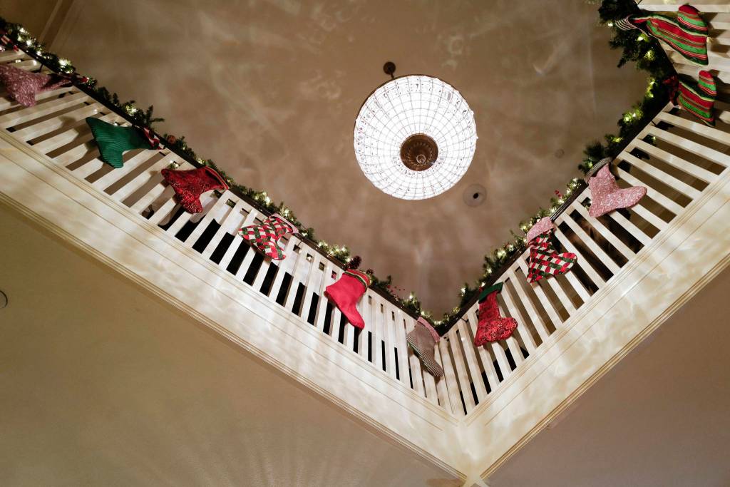 Stockings hang decorate the second floor balcony during the Governors Open House on Tuesday, Dec. 10, 2019. (Michael Penn | Juneau Empire)