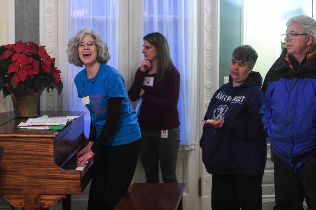 Lorrie Heagy, Executive Director of JAMM and the music teacher at Glacier Valley, sings with the students during the Governors Open House on Tuesday, Dec. 10, 2019. (Michael Penn | Juneau Empire)