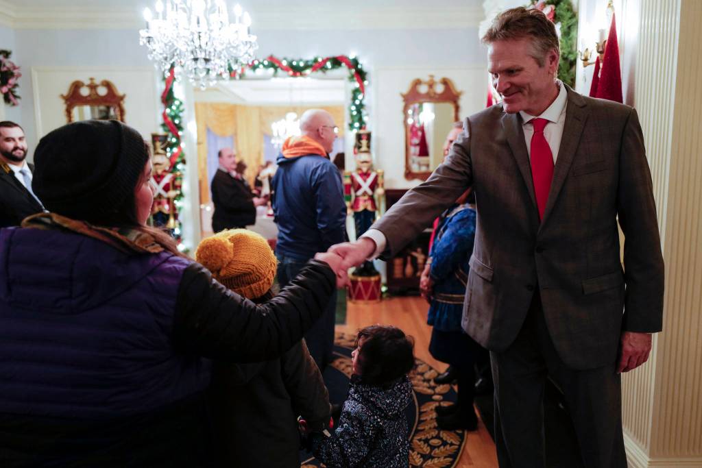 Gov. Mike Dunleavy, R-Alaska, greets Juneau residents at the Governors Open House on Tuesday, Dec. 10, 2019. (Michael Penn | Juneau Empire)