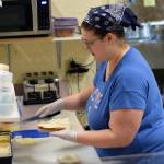 Udder Culture featuring Aurora Sweets employee Karlin Davis makes a sandwich on Dec. 10, 2019. Davis has worked at the sandwich shop since 2008. (Nolin Ainsworth | Juneau Empire)
