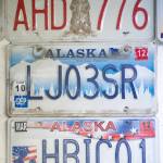 Older custom license plates decorate the wall at the Department of Motor Vehicles in Juneau in this March 2015 photo. (Michael Penn | Juneau Empire File)