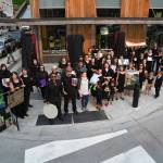 About 50 artists stand with their work in front of the Sealaska Heritage Institute on Tuesday, July 9, 2019, to protest heavy cuts to state arts programs. (Michael Penn | Juneau Empire File)