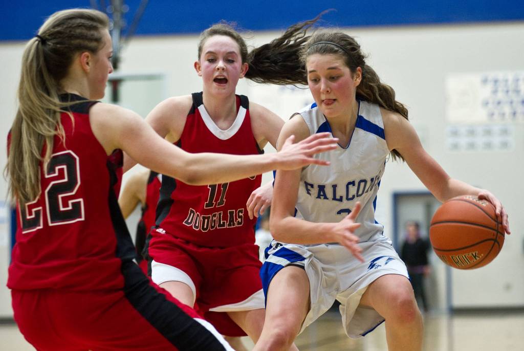 Thunder Mountains Ava Tompkins looks for dribbling space at Thunder Mountain High School in January 2014. (Michael Penn | Juneau Empire File)