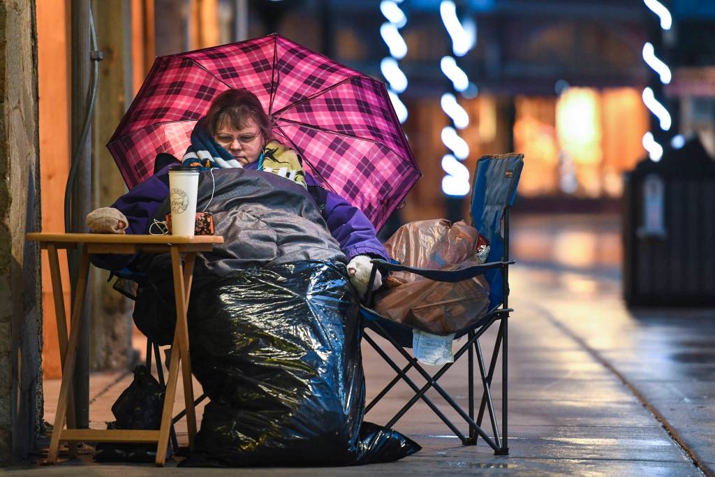 Movie fan Lynn Roldan watches an older Star Wars movie as she waits for the 10 p.m. showing of the latest movie, Star Wars: Episode IX - The Rise of Skywalker outside the 20th Century Theatre on Thursday, Dec. 19, 2019. Roldan set up at 7 a.m. and expects more people to show up in the afternoon. Roldan said she was a little sad about the end of the series but happy to be waiting to watch it. (Michael Penn | Juneau Empire)
