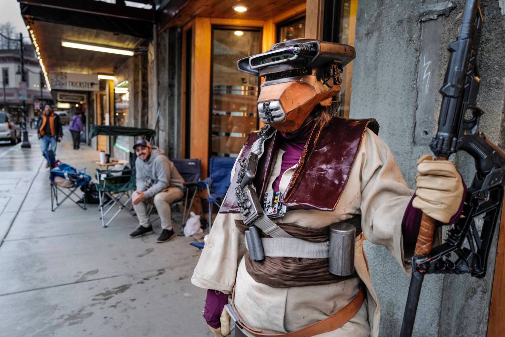Rebekah Garcia waits in line for the 10 p.m. showing of the latest movie, Star Wars: Episode IX - The Rise of Skywalker outside the 20th Century Theatre dressed as Boushh, a character from the Empire Strikes Back on Thursday, Dec. 19, 2019. (Michael Penn | Juneau Empire)