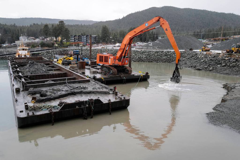 Dredging continues in the basin at the Don D. Statter Memorial Boat Harbor in Auke Bay on Wednesday, Dec. 18, 2019. The area will be used to construct floats for the charter vessel fleet. The floats will be in use by the whale watching charters in May of 2021. (Michael Penn | Juneau Empire)