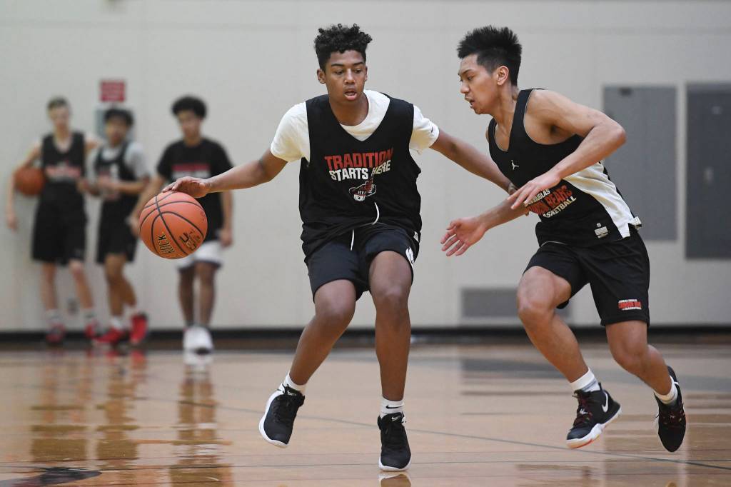 Malakai Nichols, left, drives against LJ Elizarde during boys varsity basketball practice at Juneau-Douglas High School: Yadaa.at Kalé on Tuesday, Dec. 10, 2019. (Michael Penn | Juneau Empire FIle)