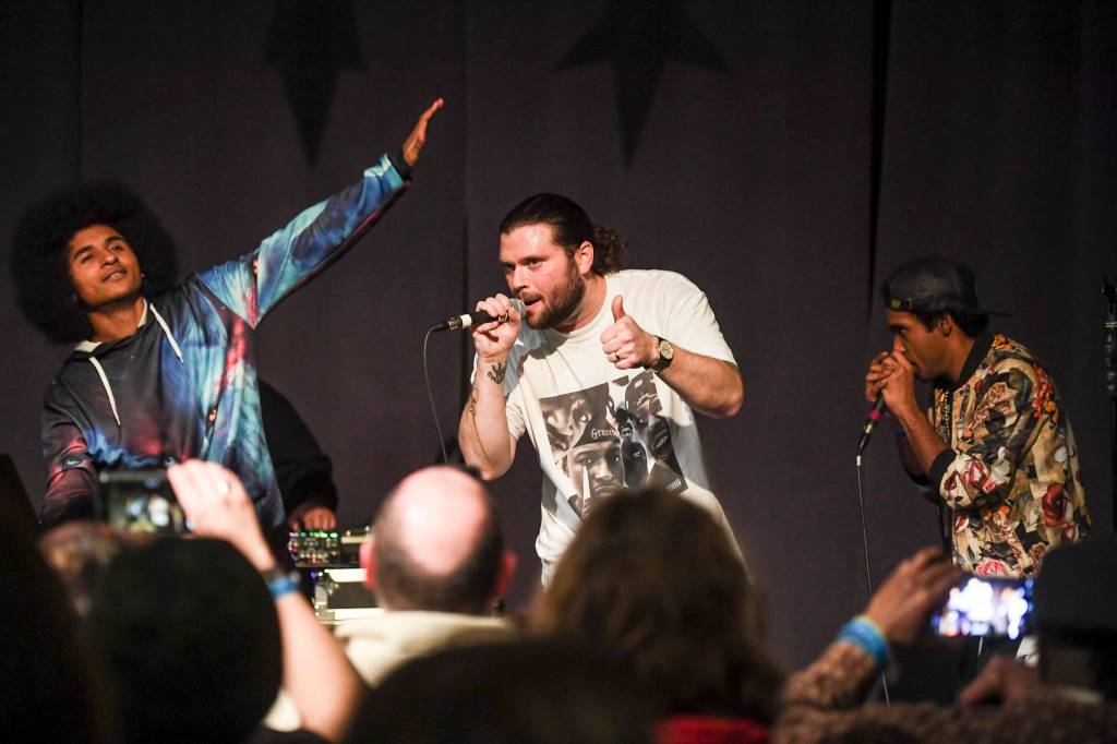 T.J. Manner Cramer, center, performs with Arias Hoyle, left, and Chris Talley during the Killah Priest of Wu Tang Southeast Tour at the Juneau Arts & Culture Center on Friday, Dec. 20, 2019. (Michael Penn | Juneau Empire)