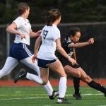 Juneau-Douglas Malia Miller, right, shoots and scores against Soldotnas Sierra Longfellow, left, and Caleigh Glassmaker at Adair-Kennedy Memorial Field on Friday, April 26, 2019. When JDHS and Soldotna rematched in the state championship match a month later, Miller scored two more goals to finish with 105 in her career, the most in Alaska girls soccer. (Michael Penn | Juneau Empire File)