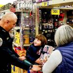Juneau Police Department Chief Ed Mercer helps a child pick out Christmas presents for their families during the annual Shop with a Cop event, sponsored by the Alaska Peace Officer Association, at Fred Meyer on Dec. 21, 2019. (Courtesy photo | Glenn Ojard)