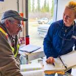 Petty Officer 3rd Class Holly Hugunin, an inspector with Coast Guard Sector Anchorage, works with Kenny Morgan, a Morgan Fuels facility manager in Kalskag, Alaska, May 16, 2019. (Lt. Cmdr. David Evans | U.S. Coast Guard)