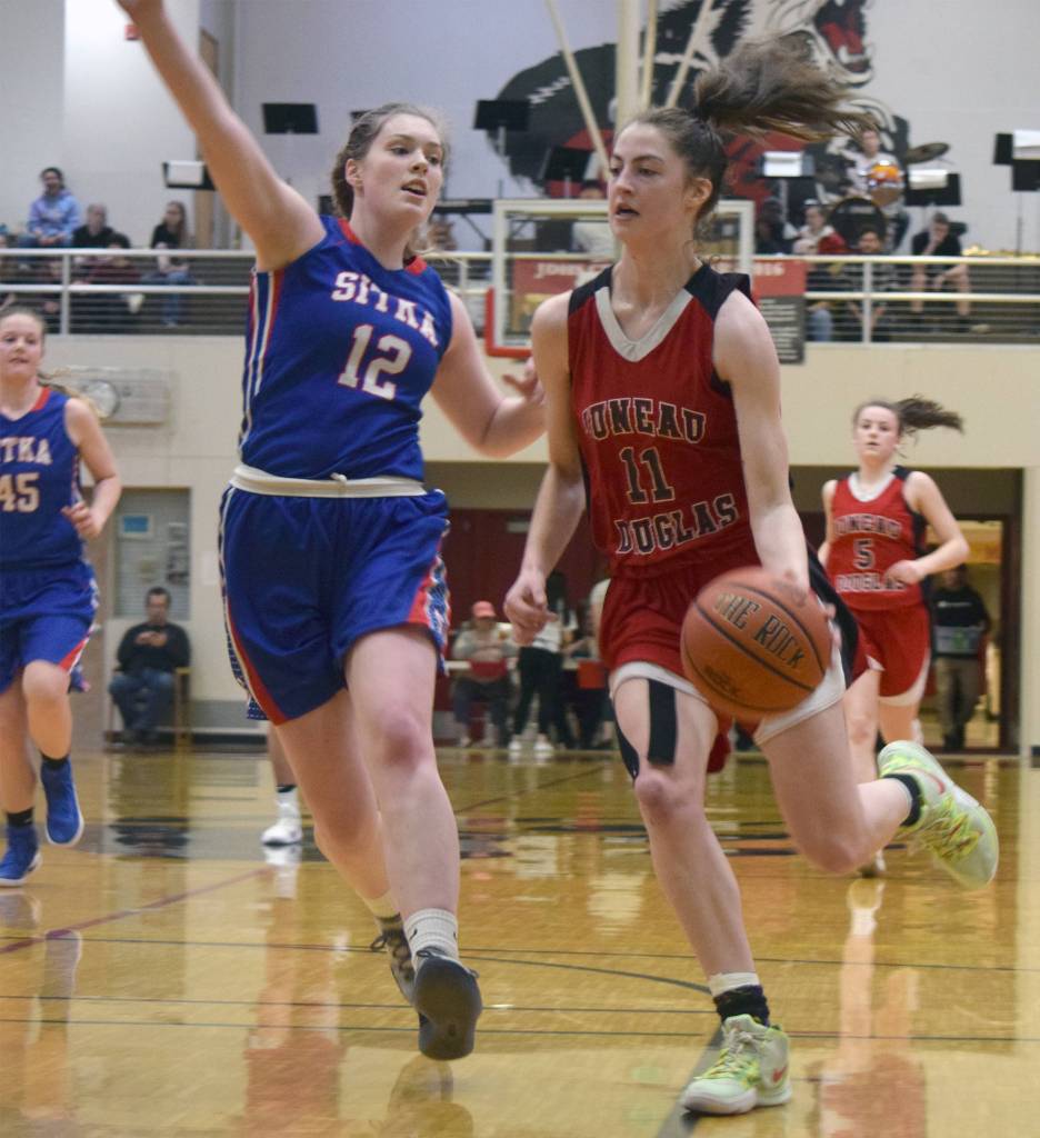Juneau-Douglas High School: Yadaat.at Kales Kendyl Carson gets around Sitkas Chloe Morrison in the fourth quarter of a game in the Princess Cruises Capital City Classic at JDHS on Monday, Dec. 30, 2019. (Nolin Ainsworth | Juneau Empire)