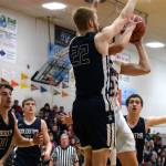 Juneau-Douglas High School: Yadaat.at Kale junior Cooper Kriegmont tries to shoot over Soldotnas Levi Rosin in the Princess Cruises Capital City Classic on Monday, Dec. 30, 2019. Soldotnas Zach Hanson, far left, Tyler Morrison, second from left, and Jersey Truesdell, far right, look on. (Nolin Ainsworth | Juneau Empire)