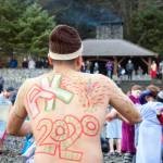 Marvin Peña sports back art Wednesday, Jan. 1, at the 2020 Polar Bear Dip. (Ben Hohenstatt | Juneau Empire)