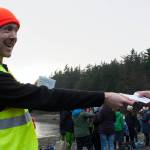 Carl Brodersen hands out a certificate of awesomeness to a participant in the 2020 Polar Dip. (Ben Hohenstatt | Juneau Empire)