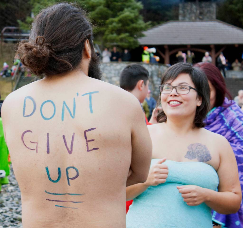 Devin Drones and BettyAnn Boyd share a laugh before doing the 2020 Polar Bear Dip Wednesday, Jan. 1 at Auke Bay Recreation Area. (Ben Hohenstatt | Juneau Empire)