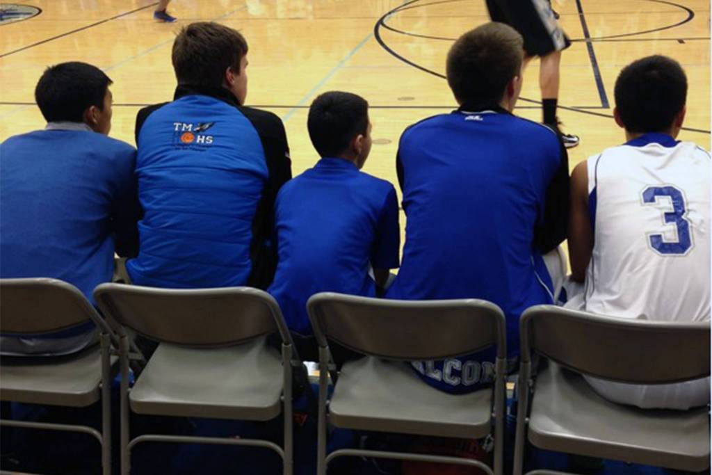Bryson Echiverri sits on the Thunder Mountain High School boys basketball bench during a game at TMHS during the 2013-14 season. Echiverri, now 17, served as the Falcons ball boy from 2009-2014. (Courtesy Photo | Jen Kemp)