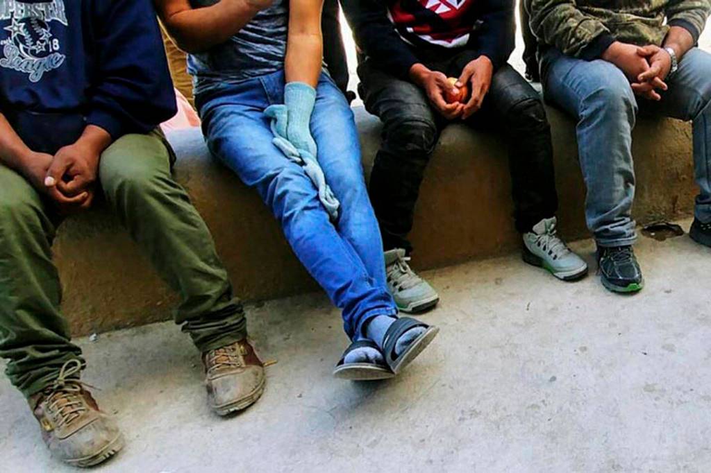 Young immigrant men wait at the border of Mexico and Arizona. (Gail Kocourek | Courtesy Photo)