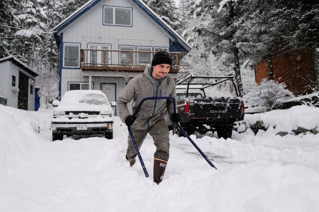 Matt Brooks clears snow out of his driveway along Douglas Highway on Tuesday, Jan. 7, 2020. (Michael Penn | Juneau Empire)