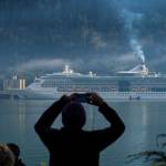 Michael Penn | Juneau Empire File                                In this Empire file photo, a cruise ship passenger photographs a ship in Juneaus downtown harbor on August 29, 2017.