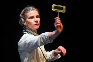 Shelley Virginia holds up a tool known as a spanker while rehearsing in front of an invited audience for Perseverance Theatres production of Silent Sky on Tuesday, Jan. 7. (Michael Penn | Capital City Weekly)