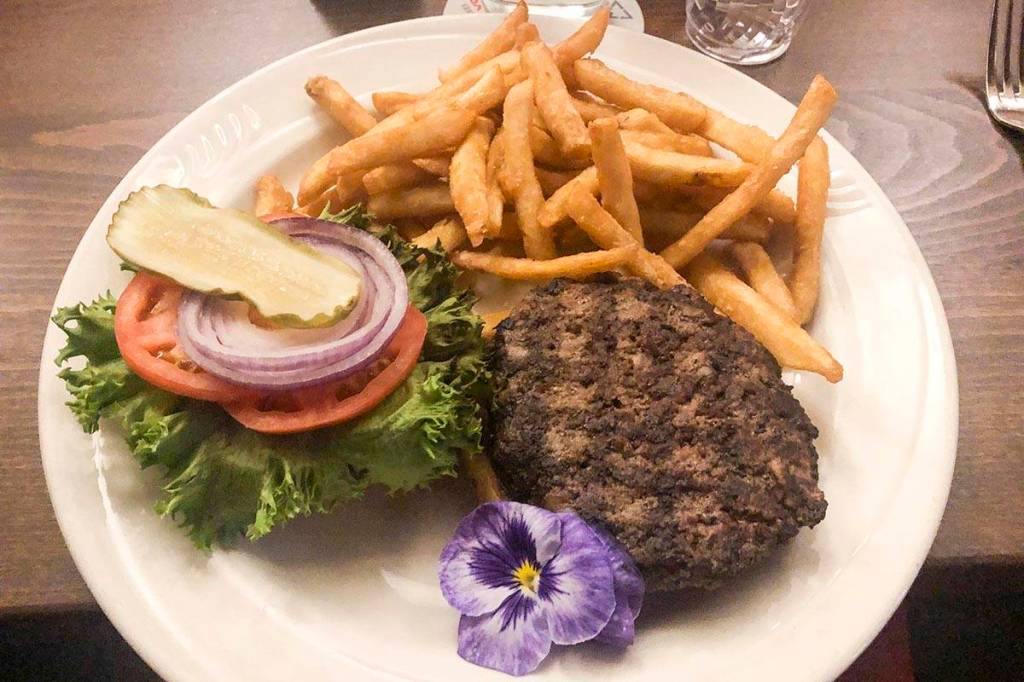 Bubble Rooms butchers grind burger, Jan. 7, 2020. (Peter Segall | Juneau Empire)