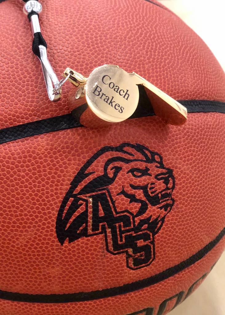 Karli Brakes whistle sits atop a basketball bearing the Anchorage Christian Schools logo. (Courtesy Photo |Kristi Waythomas)