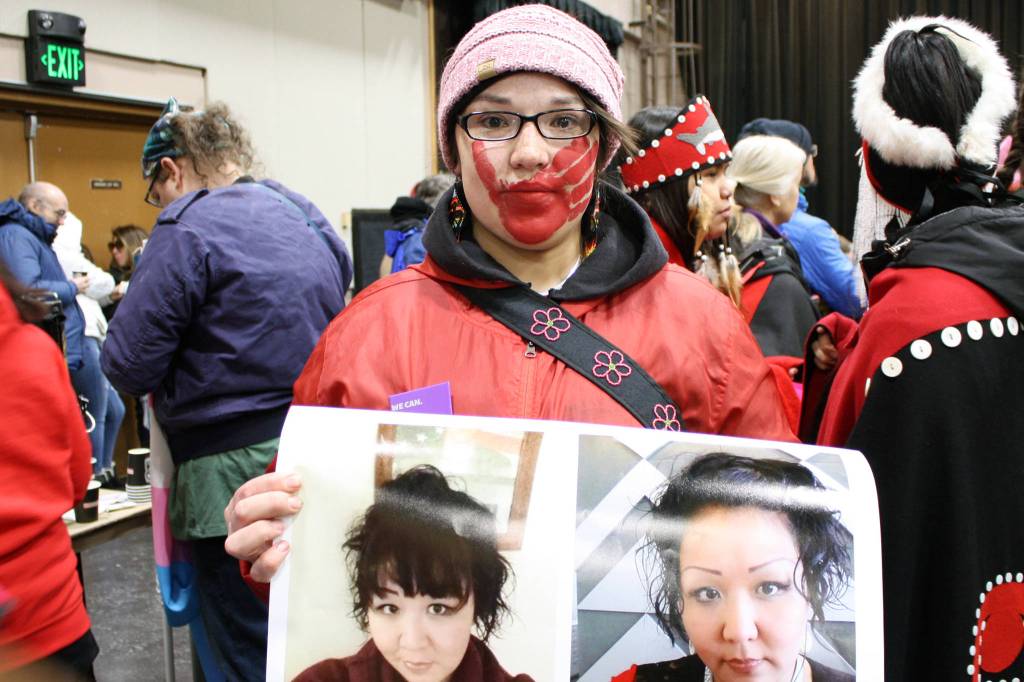 Cassandra Cropley holds a poster showing photos of her cousin, Linda Skeek, after the 2020 Womens March, Jan. 18. Skeek went missing in January 2016 and is feared dead. (Ben Hohenstatt | Juneau Empire)