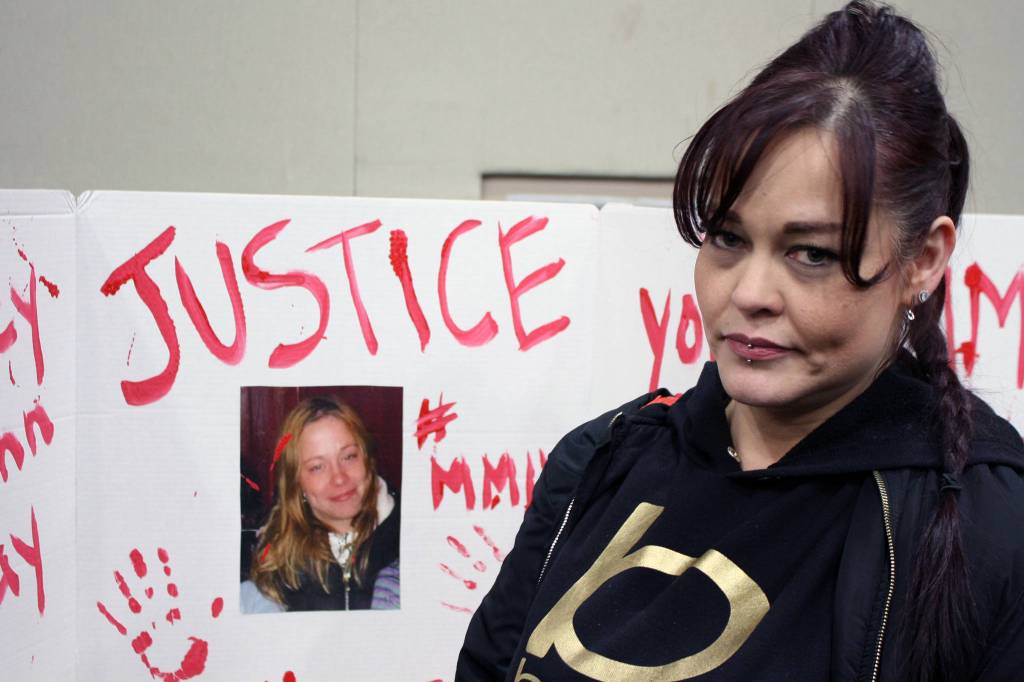 Crystal Delgado stands near a poster raising awareness of her missing sister, Tracy Day, after participating in the 2020 Womens March, Saturday, Jan. 18. (Ben Hohenstatt | Juneau Empire)