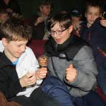 Orrin Noon, 10, Arlo Davis, 11, and Axel Boily, 10, beam at the crunchy critters they were about to eat. The boys were among the theatergoers who sampled edible insects prepared by David George Gordon, aka Bug Chef. (Ben Hohenstatt | Juneau Empire)