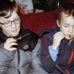 Arlo Davis, 11, and Axel Boily, 10, chow down on farm-raised locusts at the Gold Town Theater, Saturday, Jan. 18, 2020. (Ben Hohenstatt | Juneau Empire)