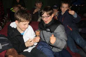 Orrin Noon, 10, Arlo Davis, 11, and Axel Boily, 10, beam at the crunchy critters they were about to eat. The boys were among the theatergoers who sampled edible insects prepared by David George Gordon, aka Bug Chef. (Ben Hohenstatt | Juneau Empire)