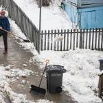 A man shovels snow near the state capitol as rising temperatures turn the roads to slush, Jan. 22, 2020. (Michael S. Lockett | Juneau Empire)