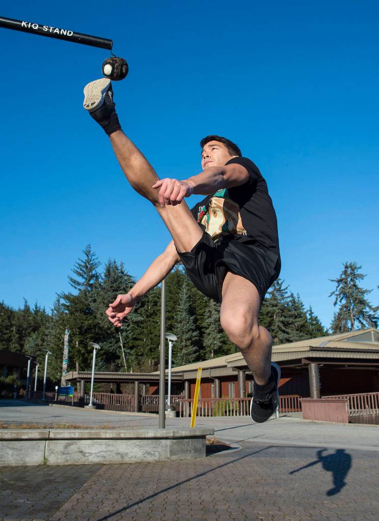 Kyle Worl demonstrates the one-foot high kick while at the University of Alaska Southeast campus on Tuesday, Nov. 7, 2017. (Michael Penn| Juneau Empire File)