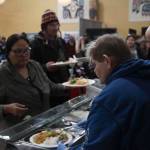 A volunteer serves food to a guest at the Juneau Coalition for Housing and Homelessness 9th annual Homeless Connect event at the Juneau Arts and Culture Center Wednesday. (Michael S. Lockett | Juneau Empire)
