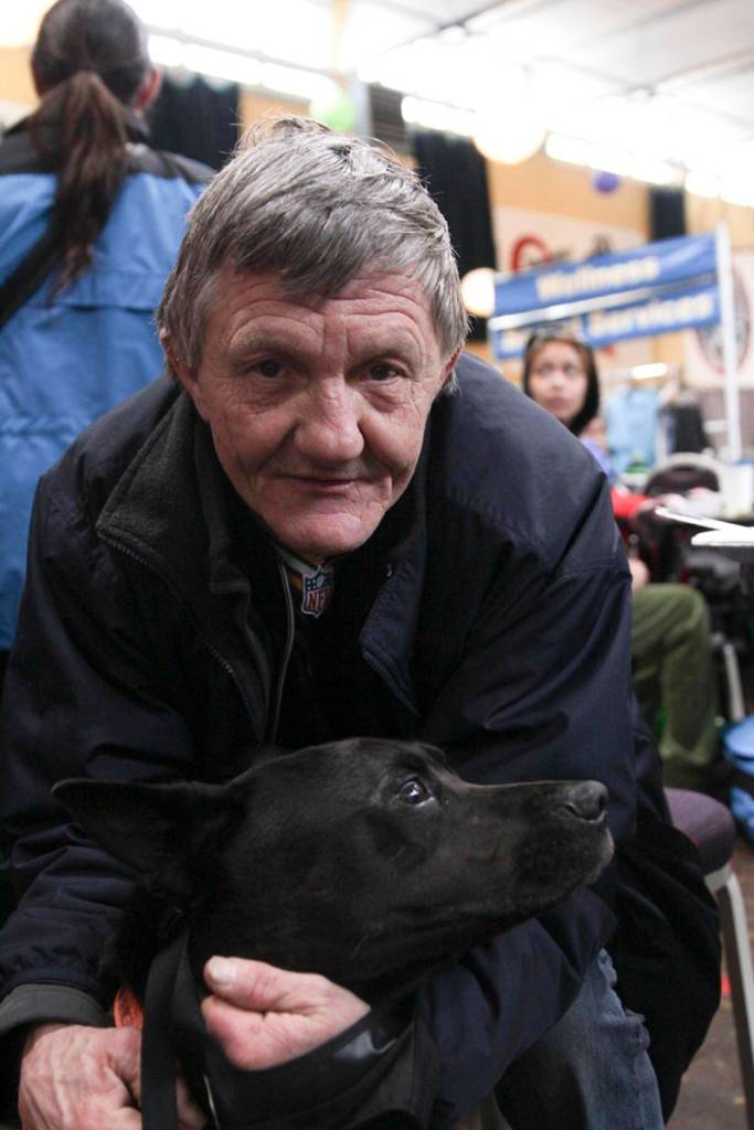 Cary Shilts, a guest, poses with his dog at the Juneau Coalition for Housing and Homelessness 9th annual Homeless Connect event at the Juneau Arts and Culture Center, Jan. 29, 2020. (Michael S. Lockett | Juneau Empire)