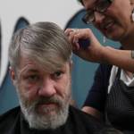 Steven Lythgoe gets his hair cut by Jamiann Hasselquist at the Zach Gordon Youth Center during the Juneau Coalition for Housing and Homelessness 9th annual Homeless Connect event, Jan. 29, 2020. (Michael S. Lockett | Juneau Empire)