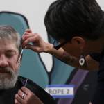 Steven Lythgoe gets his hair cut by Jamiann Hasselquist at the Zach Gordon Youth Center during the Juneau Coalition for Housing and Homelessness 9th annual Homeless Connect event, Jan. 29, 2020. (Michael S. Lockett | Juneau Empire)