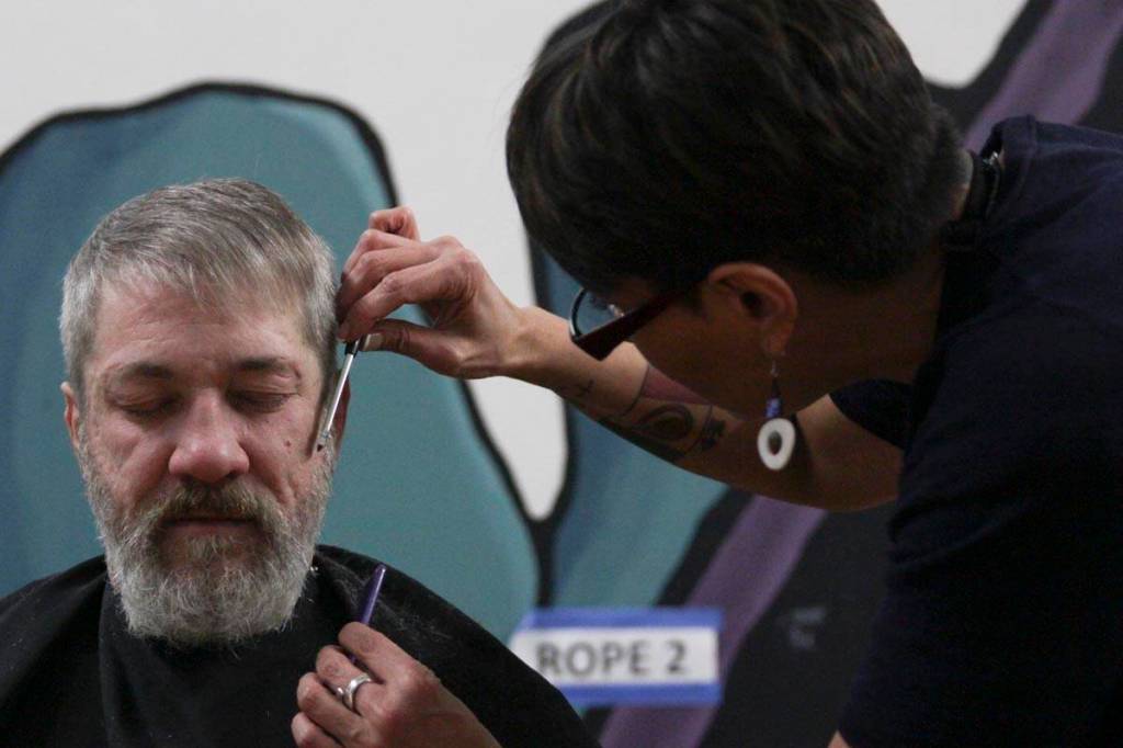 Steven Lythgoe gets his hair cut by Jamiann Hasselquist at the Zach Gordon Youth Center during the Juneau Coalition for Housing and Homelessness 9th annual Homeless Connect event, Jan. 29, 2020. (Michael S. Lockett | Juneau Empire)
