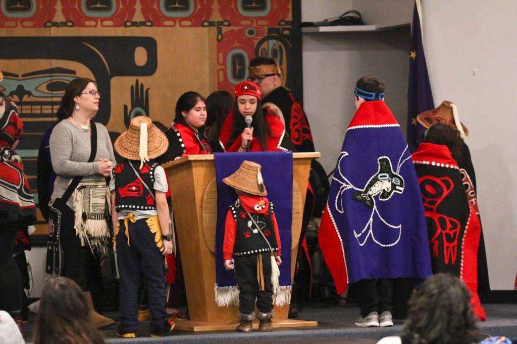 The All Nations Children dance group prepare to perform a song during the Elizabeth Peratrovich Day celebration at the Tlingit and Haida Community Council on Sunday. (Michael S. Lockett | Juneau Empire)
